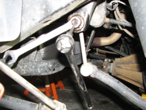 2002 Toyota Sequoia - Tools are used to work on suspension components. The SuperMotors.net logo is visible in the lower right corner.