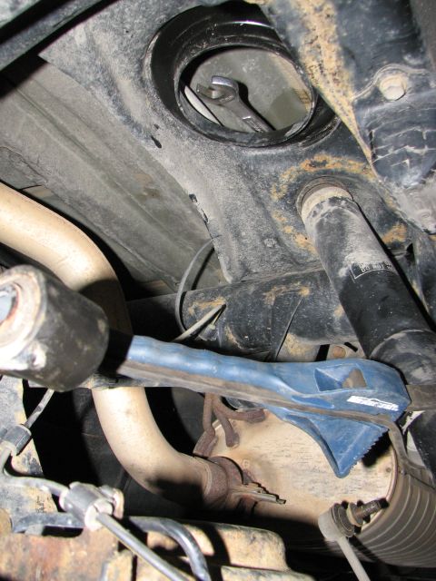 2002 Toyota Sequoia - Close-up of vehicle undercarriage components, including suspension and exhaust system.