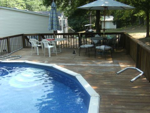 1992 Ford F-150 - A golf cart is visible in the background of this backyard scene a swimming pool and deck furniture.