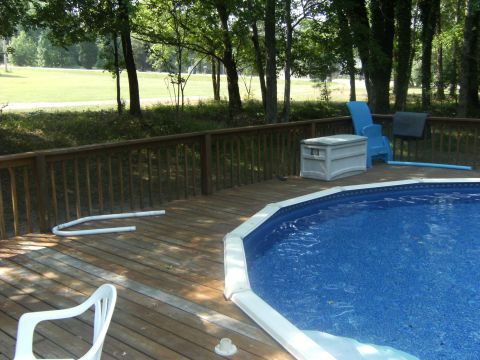 1992 Ford F-150 - A backyard scene an above-ground pool and a wooden deck with furniture.