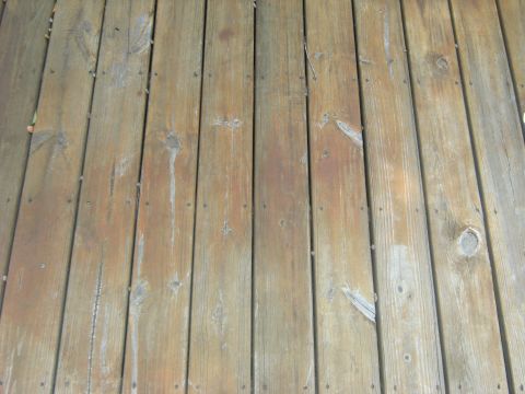 1992 Ford F-150 - The image shows a close-up view of weathered wooden deck planks with visible nails and grain patterns.