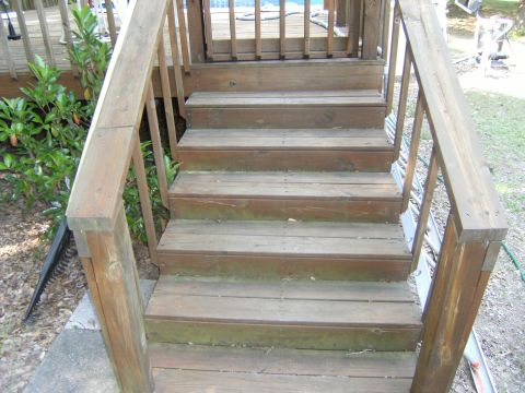 1992 Ford F-150 - Wooden deck stairs lead up to a deck area. Greenery is visible to the left.