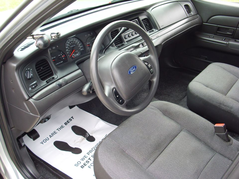 Interior of a 2004 Ford Crown Victoria showing the dashboard, steering wheel, and front seats