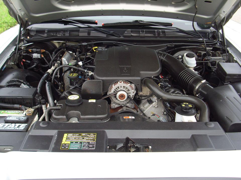 2004 Ford Crown Victoria engine bay with V8 engine, battery, and air intake visible