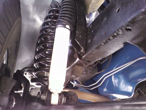 1978 Ford Bronco - Underside view shows the vehicle's suspension system, including springs and shocks.