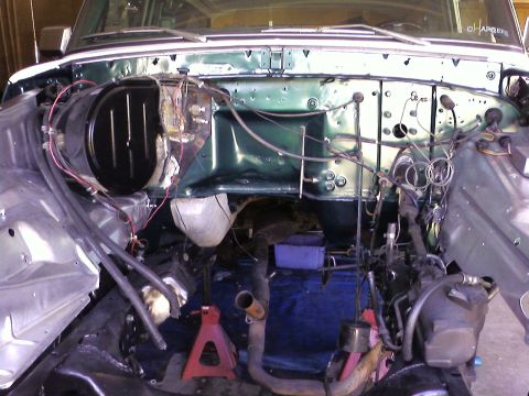 1978 Ford Bronco - The engine bay is partially disassembled, revealing the firewall and various components during a restoration project.