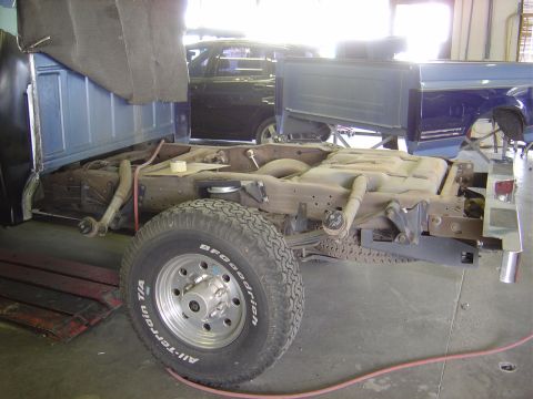 1996 Ford F-250 - The chassis and frame of a 1996 Ford F-250 are shown in a workshop setting, with another truck visible in the background.