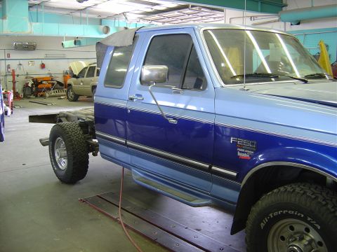 1996 Ford F-250 - A 1996 Ford F-250 truck is shown in a workshop, missing its bed and undergoing work.