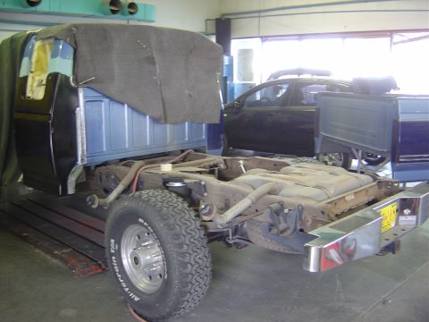 1996 Ford F-250 - The rear section of a truck chassis is shown, with a tarp covering the cab and bed area.