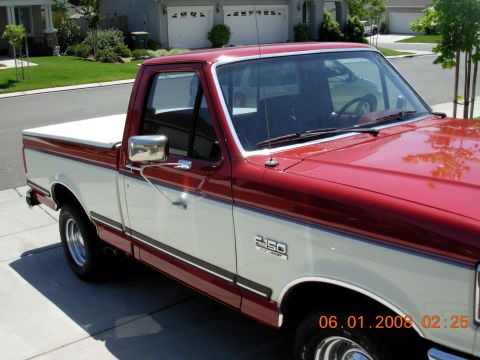 1988 Ford F-150 - This 1988 Ford F-150 pickup truck features a distinctive two-tone red and white paint scheme.