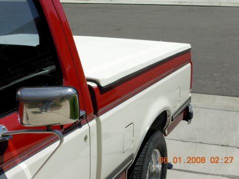 1988 Ford F-150 pickup truck, two-tone white and red paint, side view