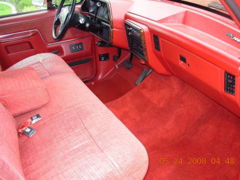 1988 Ford F-150 — Red interior of a truck, showing the bench seat, dashboard, and steering wheel. The date 05.24.2008 is visible