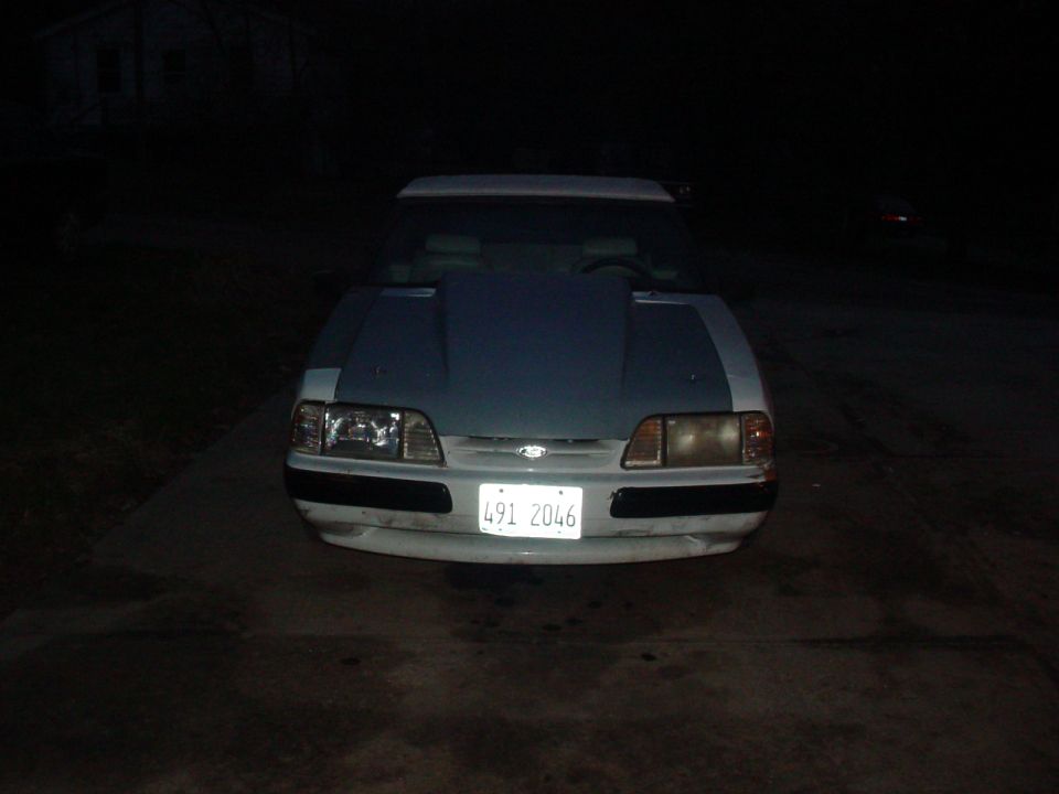 White 1990 Ford Mustang front view, aftermarket hood, license plate 491 2046