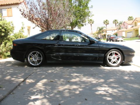 1995 Ford Probe - Side profile of a black 1995 Ford Probe GT with silver alloy wheels.