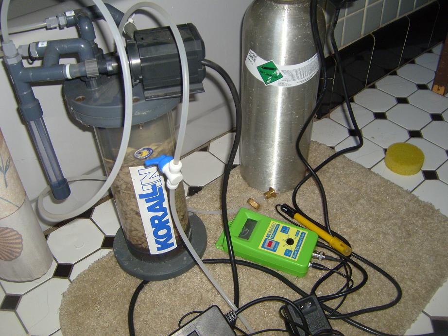 Aquarium CO2 regulator and filter system with a metal cylinder and green testing device