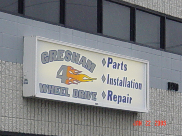 Illuminated wall sign reading Gresham 4 Wheel Drive Parts Installation Repair with flame logo