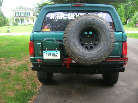 1996 Ford Bronco - This green 1996 Ford Bronco is equipped with a rear-mounted spare tire, jerry can, and a heavy-duty bumper.