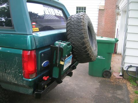 1996 Ford Bronco - Rear view of a green 1996 Ford Bronco a spare tire, jerry can, and aftermarket bumper.