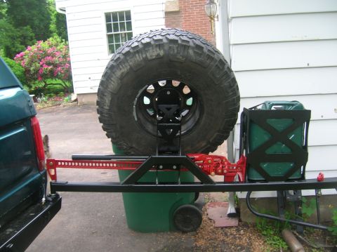 1996 Ford Bronco - Rear view of a 1996 Ford Bronco showing aftermarket bumper modifications including a spare tire mount and jerry can holder.