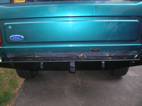 1996 Ford Bronco - The rear of a teal 1996 Ford Bronco is shown, a black aftermarket bumper with a trailer hitch.