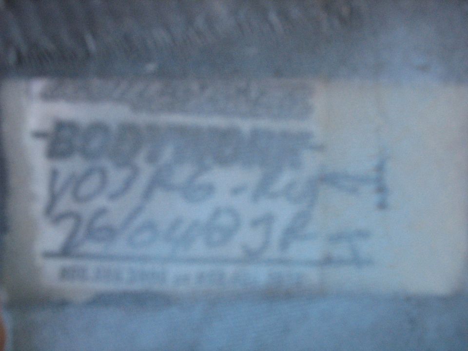 Label on motorcycle part with handwritten text "YOJ16-R1 261003J4"