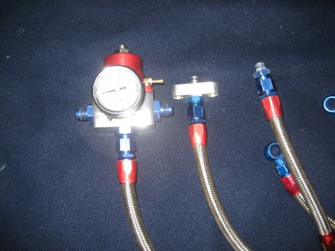1993 Ford Probe - Fuel pressure regulator and braided lines shown against a dark background.