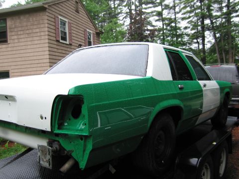 1991 Ford LTD Crown Victoria - This sedan, possibly a 1991 Ford Crown Victoria LTD, is shown on a trailer with a fresh two-tone green and white paint job.