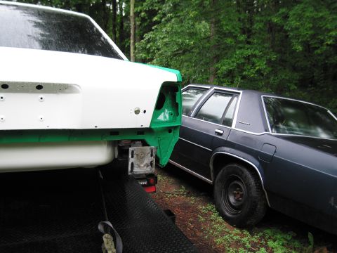 1991 Ford LTD Crown Victoria - Rear view of a 1991 Ford Crown Victoria LTD undergoing work, parked beside another vehicle.