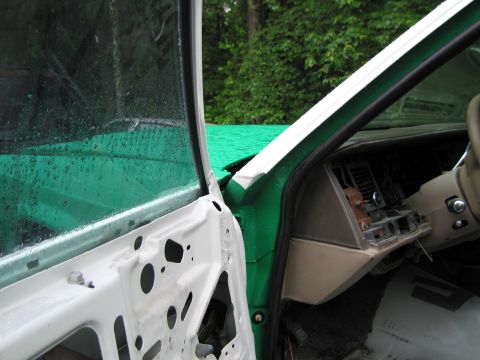 1991 Ford LTD Crown Victoria - The interior of a 1991 Ford Crown Victoria LTD shows a disassembled dashboard and exposed door panel.