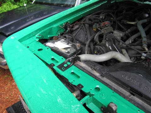1991 Ford LTD Crown Victoria - Engine bay of a 1991 Ford Crown Victoria LTD, showing the battery and engine components.
