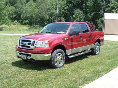 2008 Ford F-150 - This red Ford F-150 pickup truck features a chrome grille and tan lower body panels.