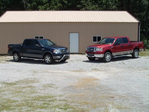 2008 Ford F-150 - Two 2008 Ford F-150 trucks are parked outside a building.