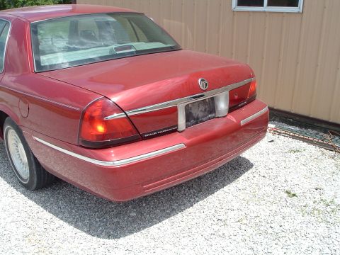 1999 Mercury Grand Marquis - Rear view of a red 1999 Mercury Grand Marquis parked outdoors.