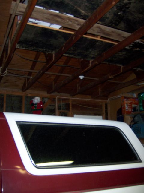 1991 Ford Bronco - Vehicle parked inside a garage with visible structural beams and a Santa decoration.