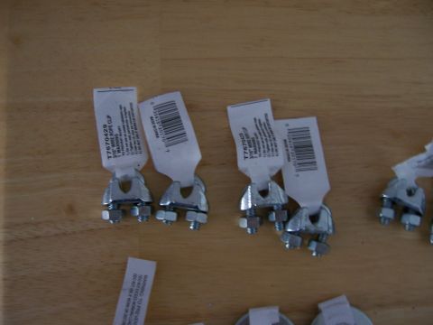 1991 Ford Bronco - Multiple wire rope clips are shown on a wooden surface, with labels indicating product information.