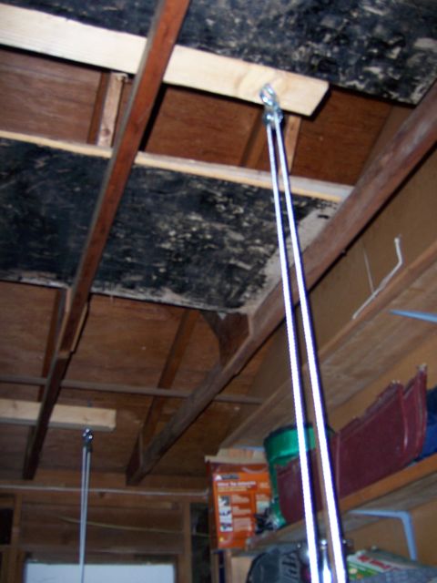 1991 Ford Bronco - A garage ceiling with a pulley system and storage shelves visible in the background.