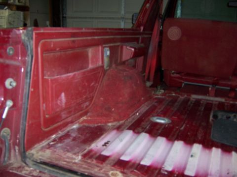 1991 Ford Bronco - Interior view of a 1991 Ford Bronco, highlighting the red carpet and side paneling.
