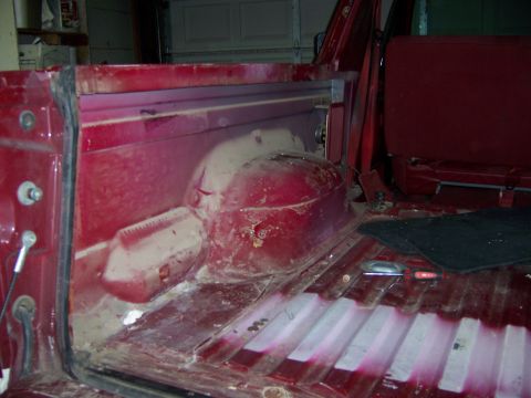 1991 Ford Bronco - The interior of a red SUV, showing the cargo area and rear seats.