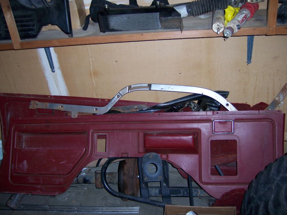 Maroon car door panel with chrome trim and black interior components