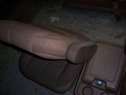 1991 Ford Bronco - Brown cloth seat and center console with cup holders, likely from an older SUV.