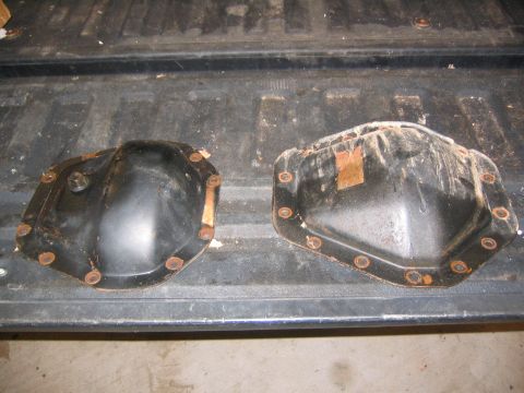 2005 Ford F-250 - Two differential covers are shown, one on the left and one on the right, on a truck bed.