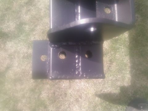 1988 Ford Bronco - Close-up of a black metal bracket with welded joints and mounting holes.