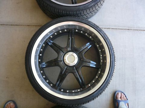 1996 Ford Probe - A close-up of a black aftermarket wheel and tire, showing its intricate design and polished rim.