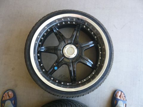 1996 Ford Probe - Aftermarket wheel and tire assembly shown from above on a concrete surface.