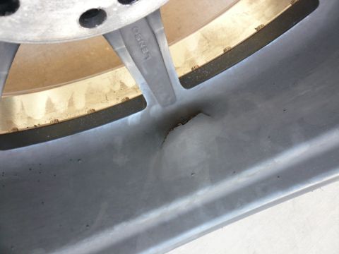 1996 Ford Probe - A close-up view shows damage to a wheel rim, with the brand name 'LENSO' visible on one of the spokes.
