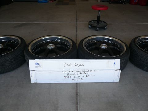 1996 Ford Probe - Four aftermarket wheels and tires are displayed, with a handwritten sign indicating "Bomb Squad" and sale details.