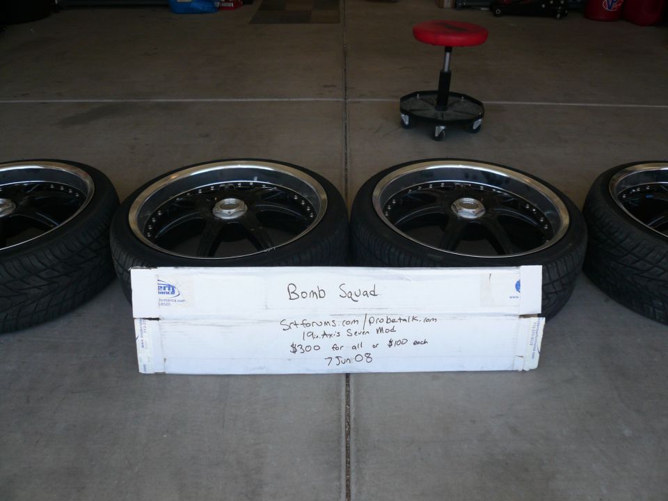 Four black aftermarket wheels with tires, labeled "Bomb Squad"