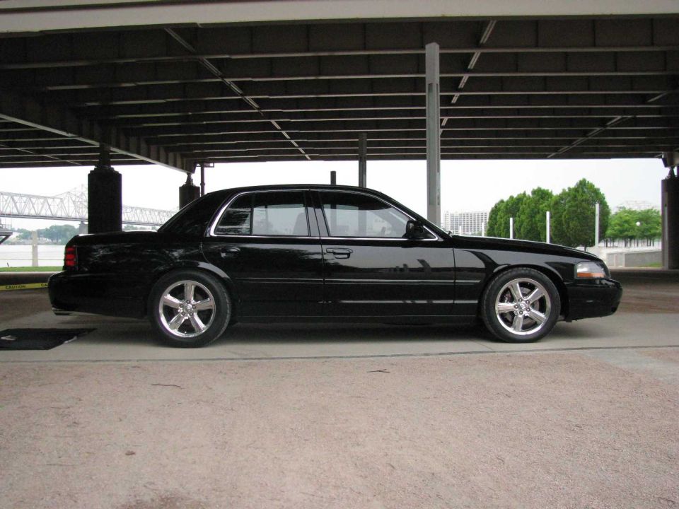 Black 2003 Mercury Marauder parked under a covered structure, side view
