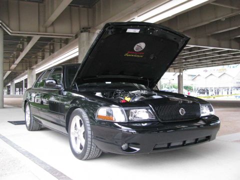 2003 Mercury Marauder - A black 2003 Mercury Marauder is parked with its hood open, revealing the engine and underhood details.