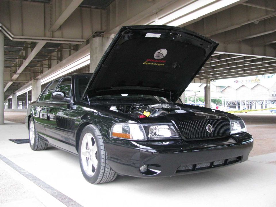 Black 2003 Mercury Marauder with hood open, showing engine and interior of hood